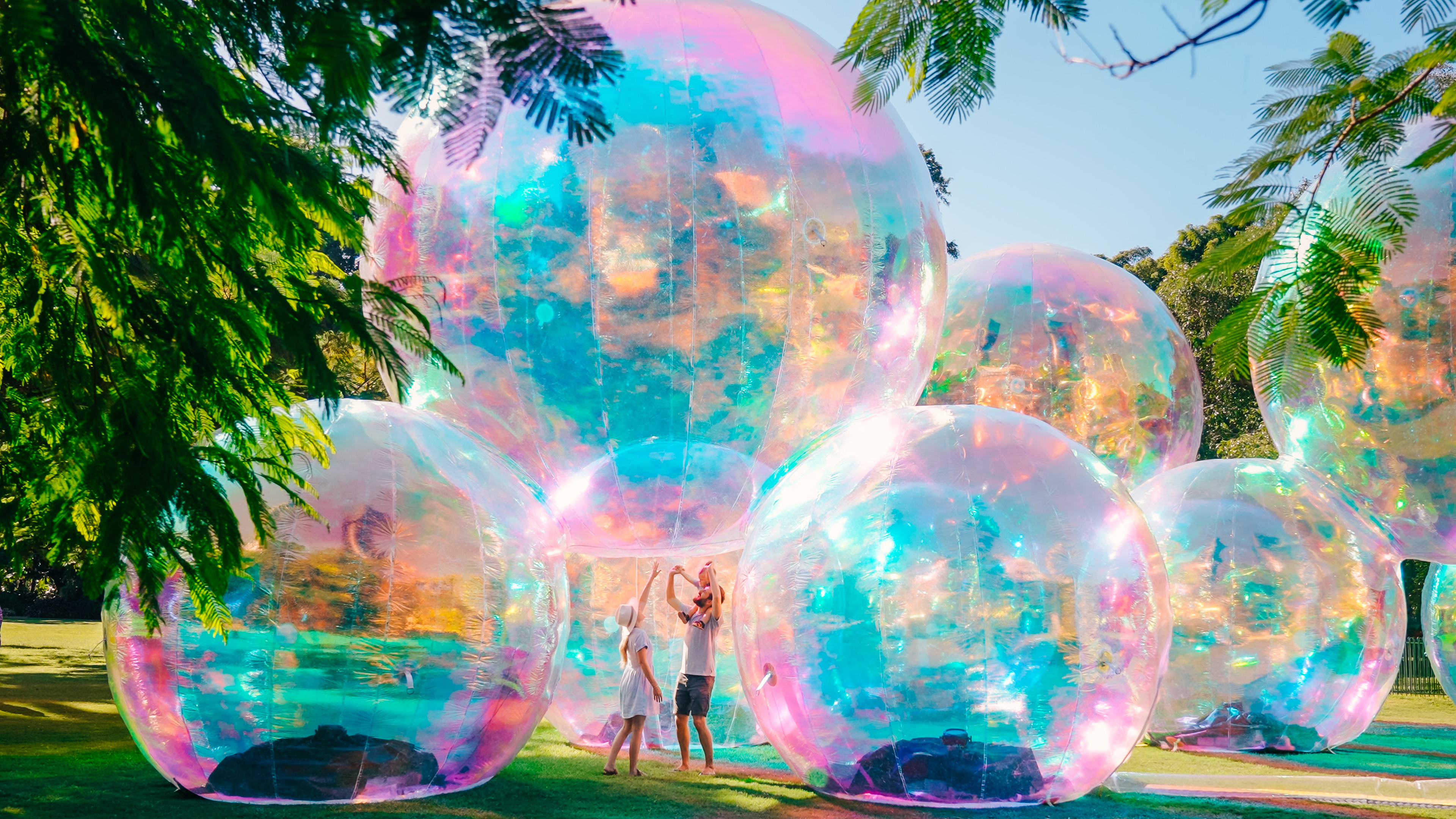 A family enjoying the huge bubbles at World Science Festival Brisbane